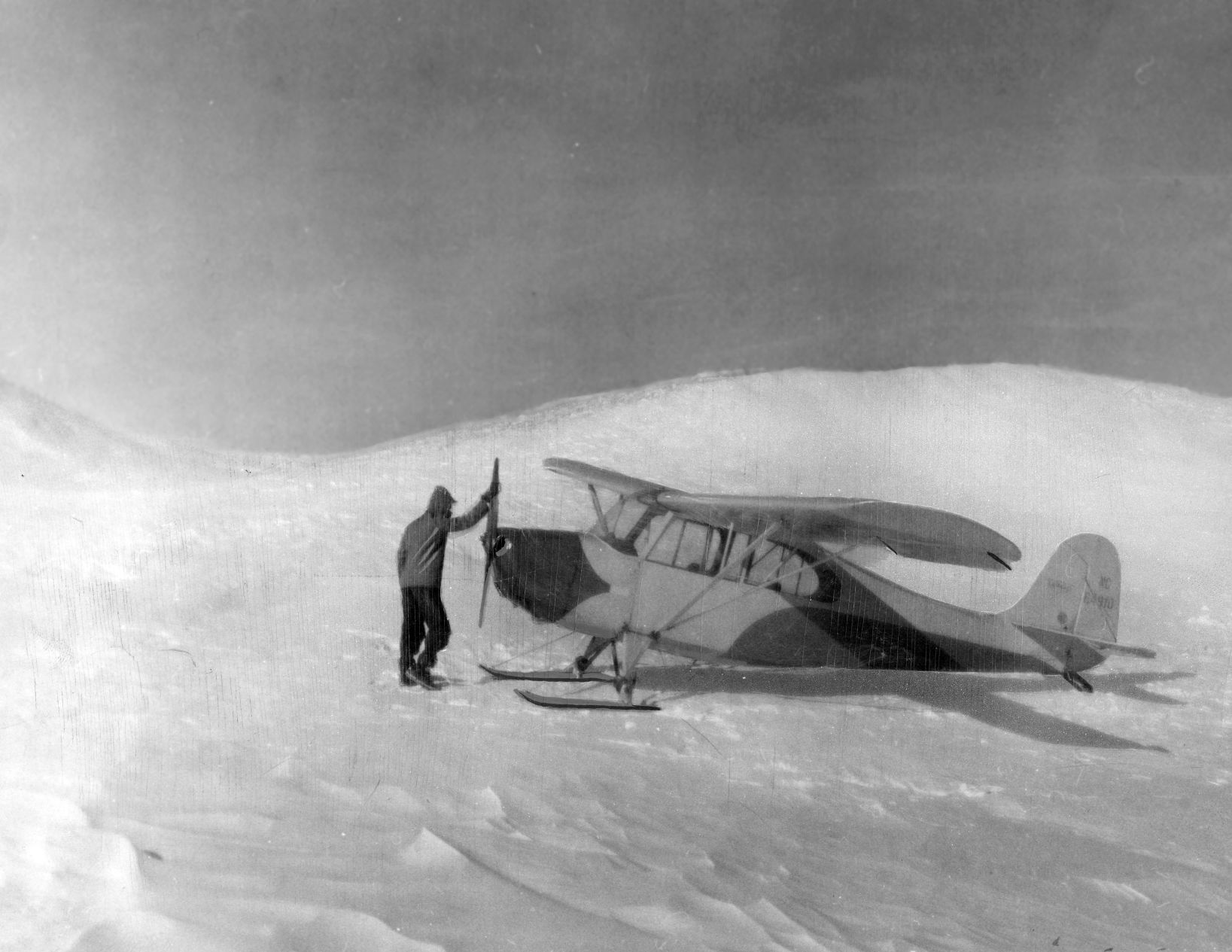 Pilot Leonard Abart of Bassett was lucky to find a landing spot among the snow-banked hills near Amy Jordan's house 35 miles south of Bassett. Published Feb. 5, 1949.